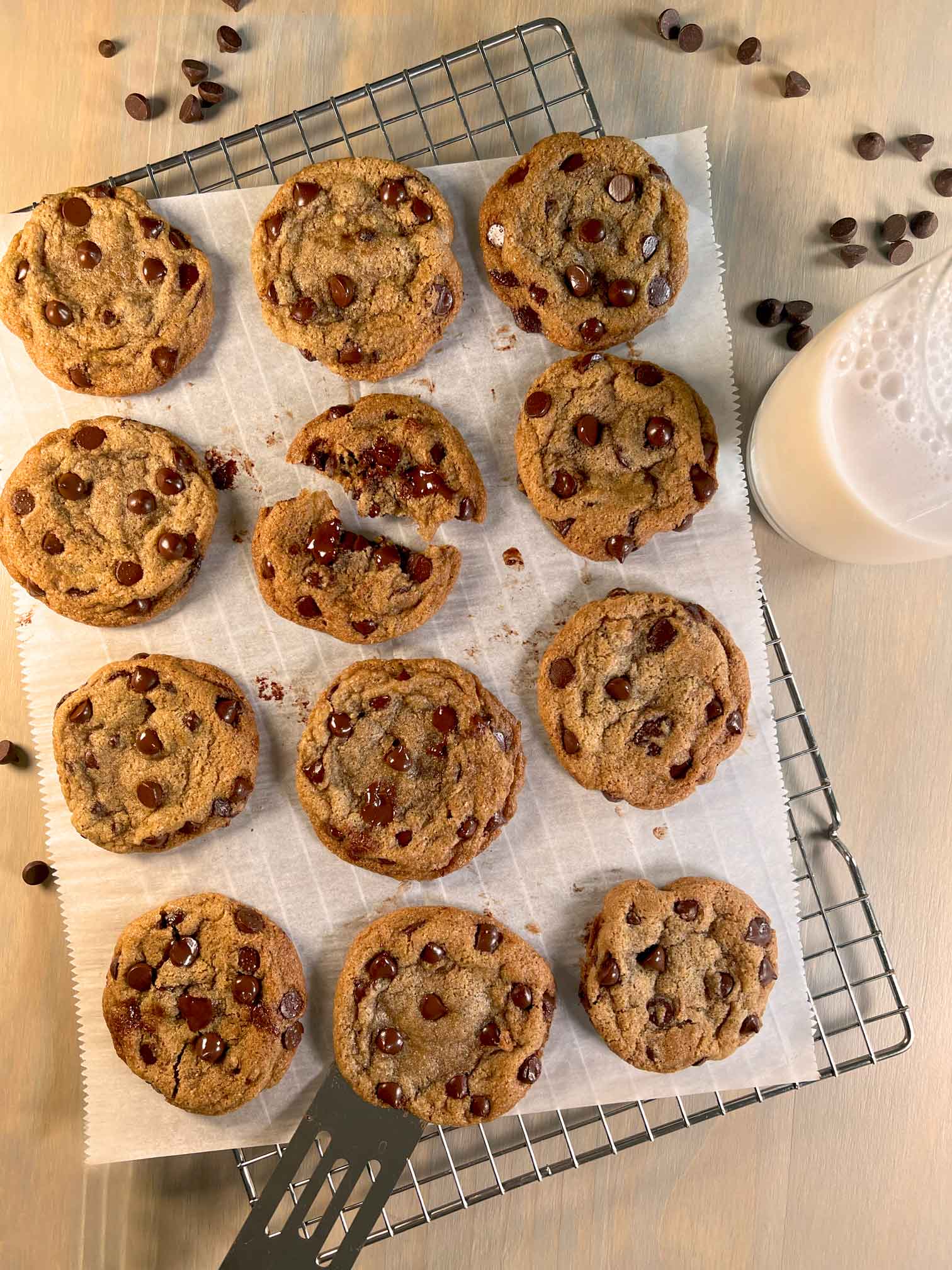 Dairy and Gluten-free chocolate chip cookies arranged on a parchment sheet atop of a cooling rack