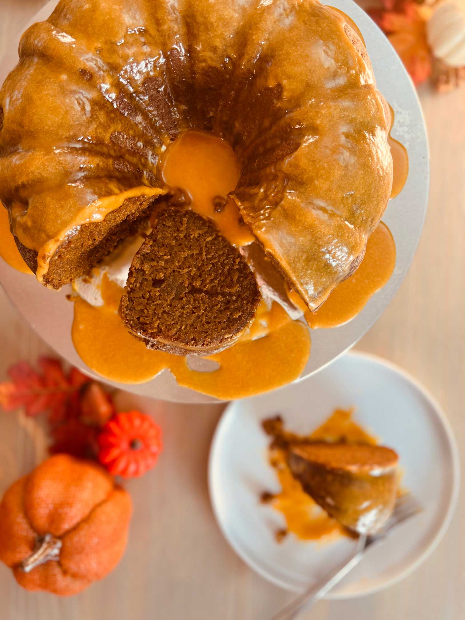 Dairy-free Pumpkin Stout Gingerbread cake arranged on a pedestal with pumpkin icing.
