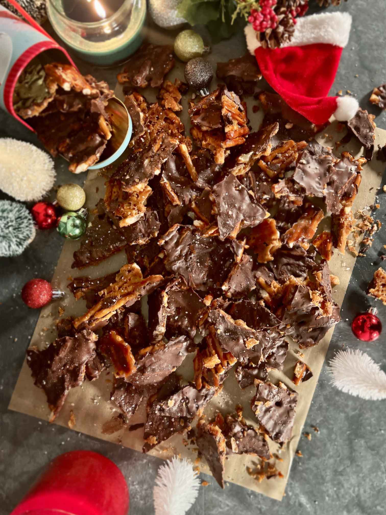 Salted Pretzel Christmas Crack arranged on stone counter with Christmas Decor